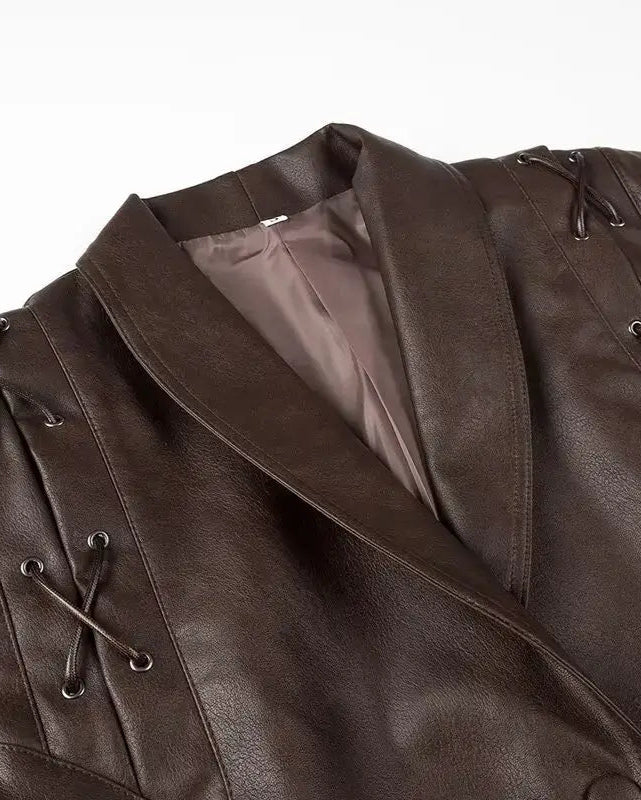 Liora Structured Wrap Jacket in rich faux leather with exaggerated shoulders and decorative lacing details.